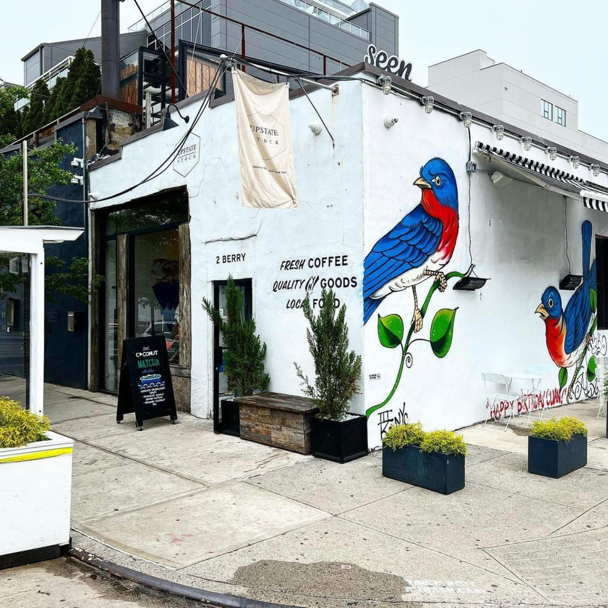 The outside of the Upstate Stock store in Brooklyn painted with two large red, white and blue birds.